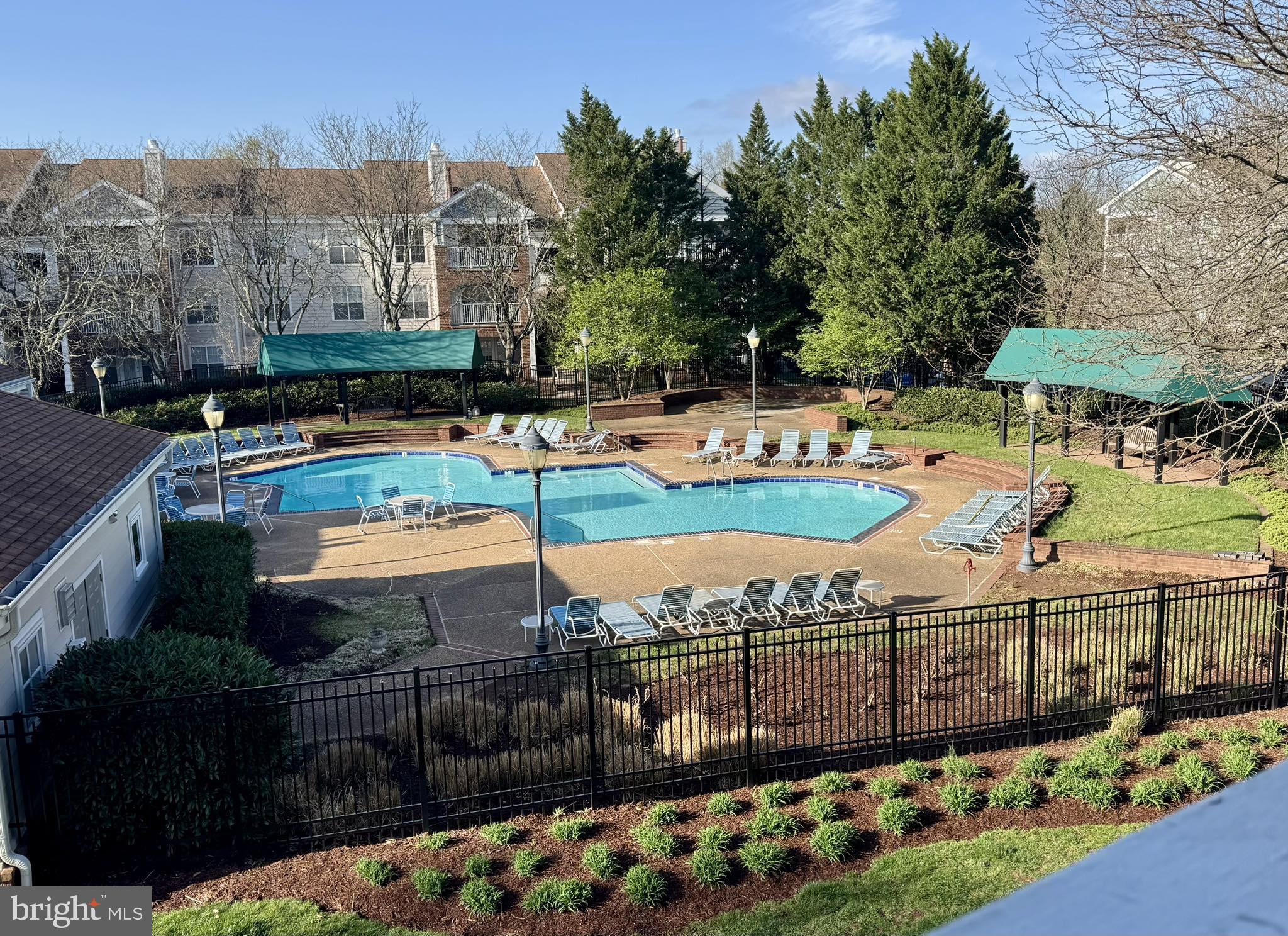 20965 Timber Ridge Terrace, Unit 304 Ashburn, VA 20147 - Photo 58 of 61 a view of a swimming pool with a patio