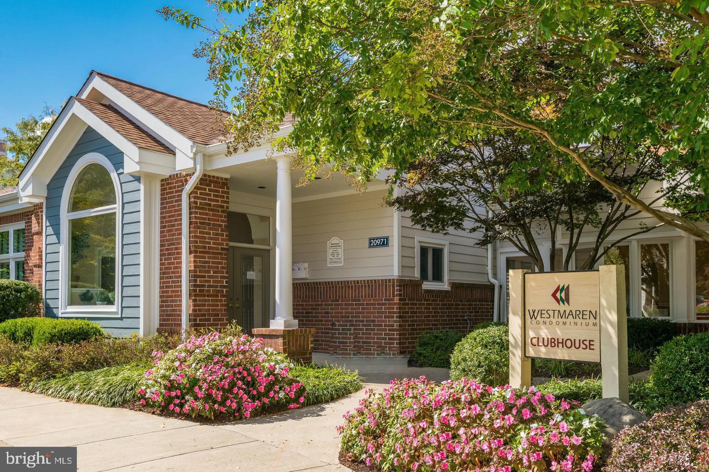 20965 Timber Ridge Terrace, Unit 304 Ashburn, VA 20147 - Photo 6 of 61 a front view of a house with garden