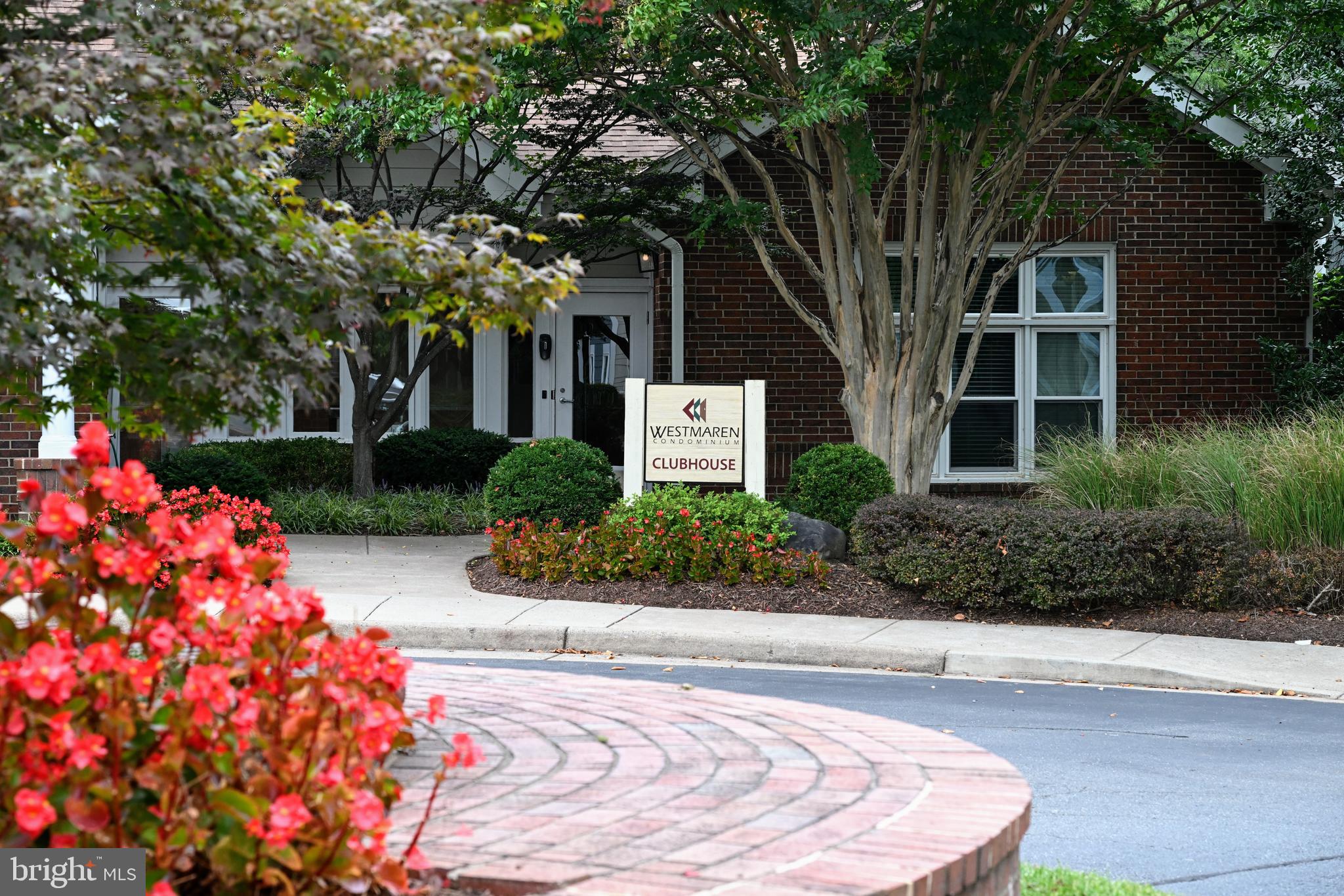 20965 Timber Ridge Terrace, Unit 304 Ashburn, VA 20147 - Photo 60 of 61 a front view of a house with garden