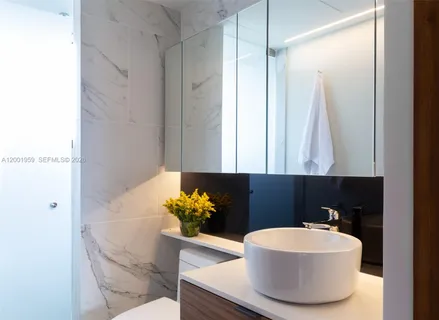 a bathroom with a sink a mirror and a bathtub