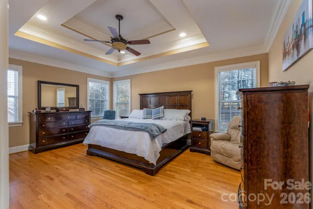 a bed room with a bed window and a ceiling fan