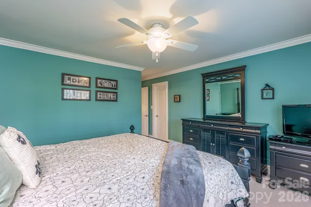 a bedroom with a large bed and a dresser