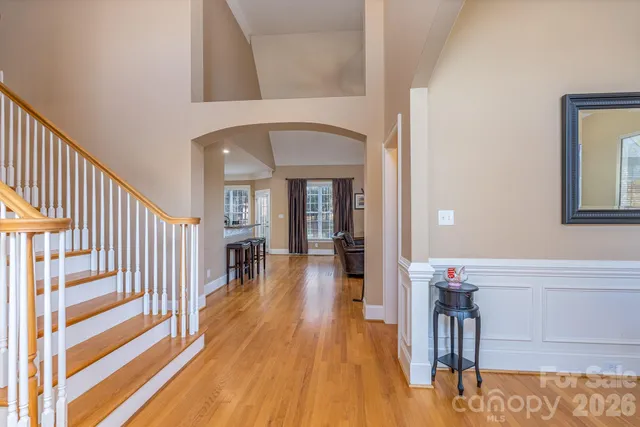 a view of a hallway view with wooden floor and staircase