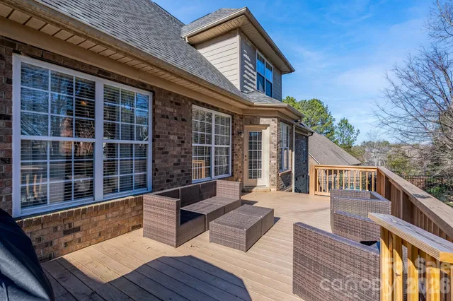 a view of a wooden chairs and a table in the balcony