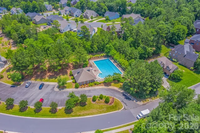 an aerial view of residential house with outdoor space and swimming pool