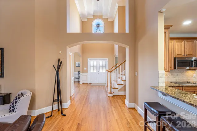 a view of a hallway with furniture and wooden floor