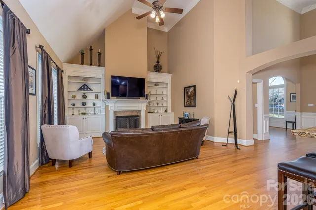 a living room with fireplace furniture and a flat screen tv