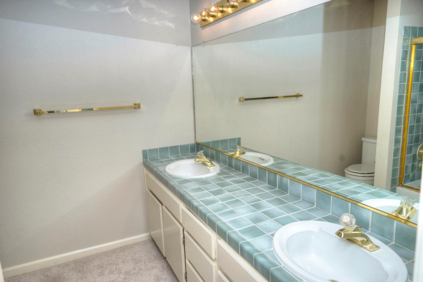 21 Merion Road Half Moon Bay, CA 94019 - Photo 16 of 17 a bathroom with a granite countertop sink and a mirror