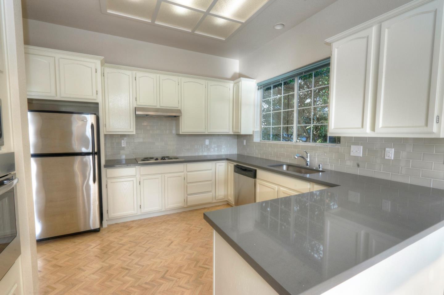 21 Merion Road Half Moon Bay, CA 94019 - Photo 2 of 17 a kitchen with a refrigerator sink and cabinets