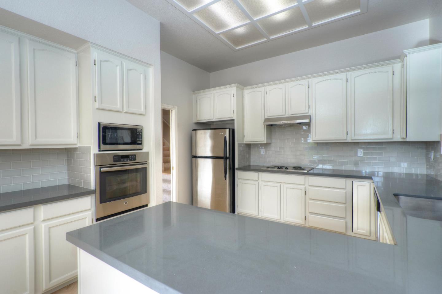 21 Merion Road Half Moon Bay, CA 94019 - Photo 4 of 17 a kitchen with kitchen island granite countertop a sink stainless steel appliances and cabinets