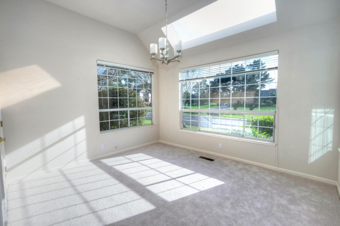 21 Merion Road Half Moon Bay, CA 94019 - Photo 6 of 17 a view of an empty room with windows and chandelier