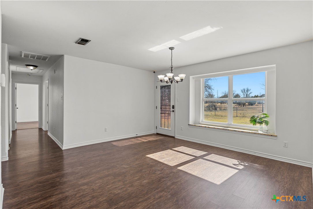 519 Pleasant View Road Troy, TX 76579 - Photo 12 of 33 a view of an empty room with a window and wooden floor