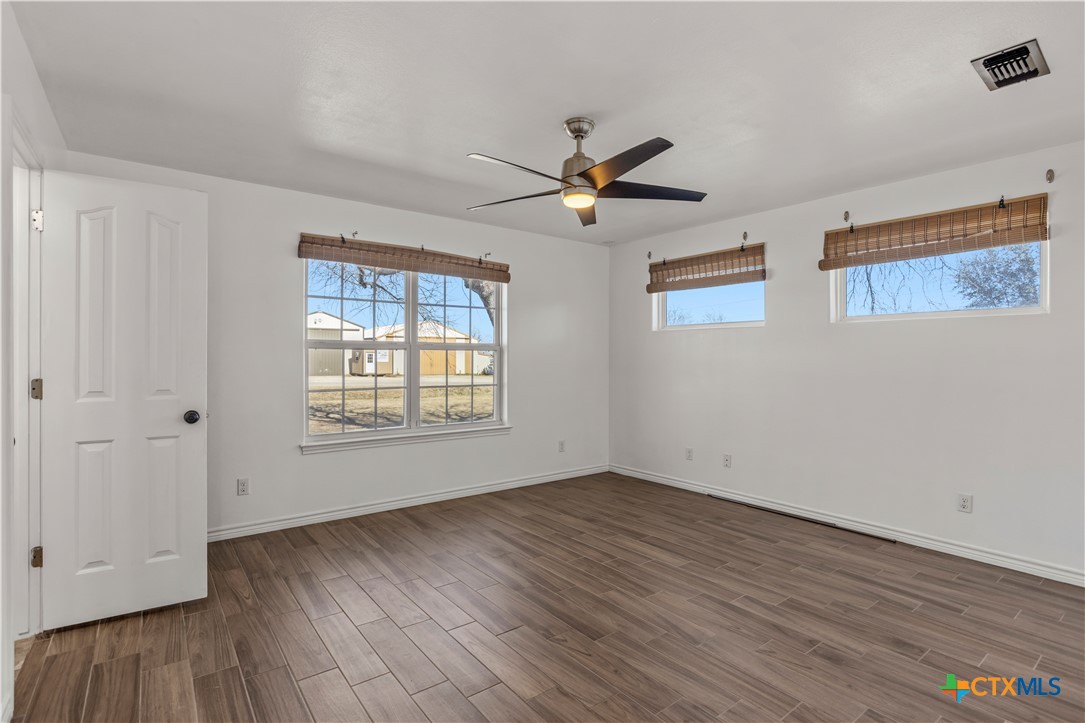 519 Pleasant View Road Troy, TX 76579 - Photo 14 of 33 a view of empty room with wooden floor and fan