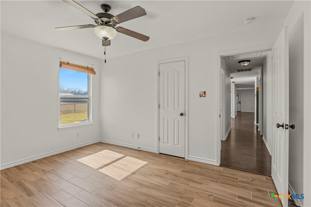 519 Pleasant View Road Troy, TX 76579 - Photo 19 of 33 wooden floor in an empty room with a window