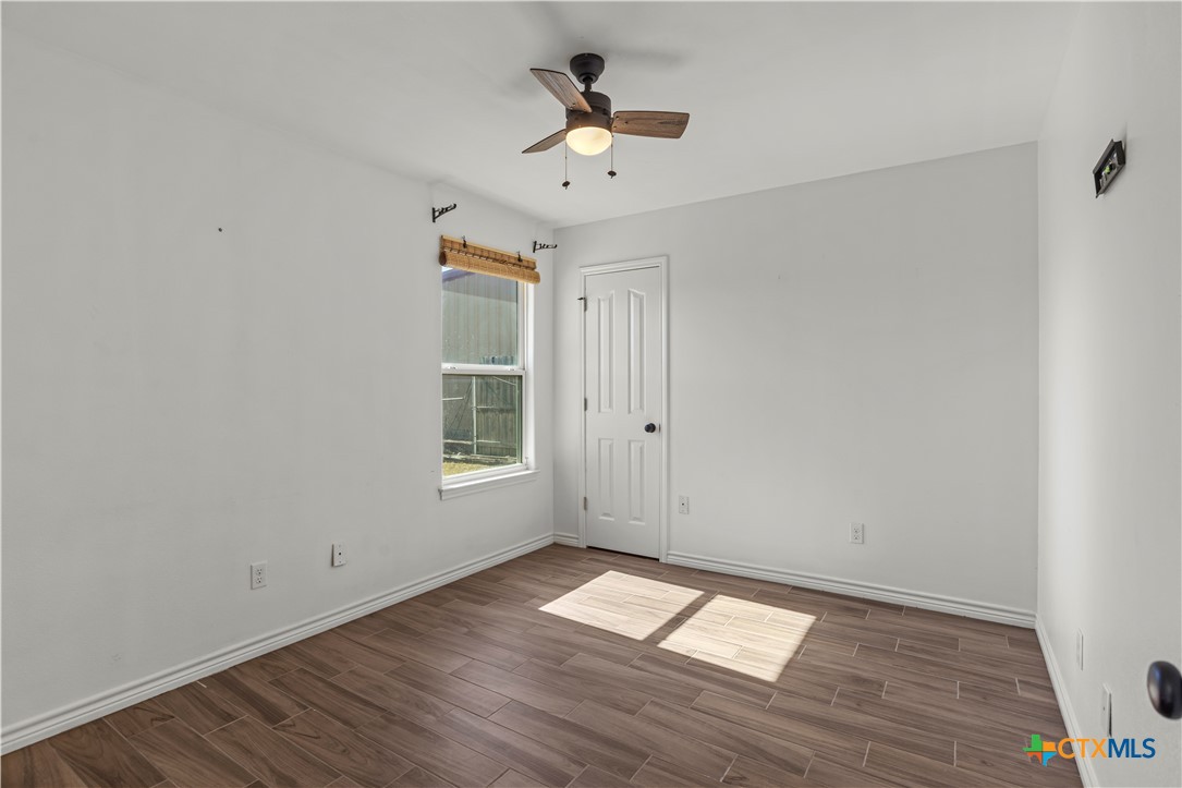 519 Pleasant View Road Troy, TX 76579 - Photo 22 of 33 wooden floor in an empty room with a window
