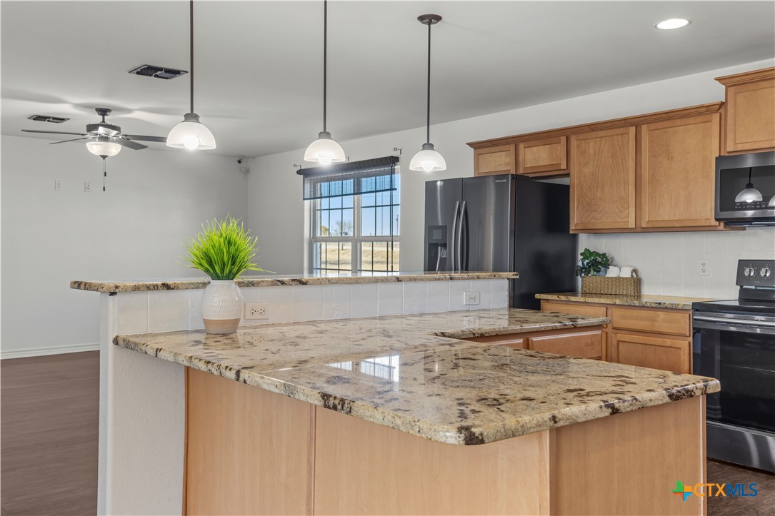 519 Pleasant View Road Troy, TX 76579 - Photo 6 of 33 a kitchen with kitchen island granite countertop a sink a counter top space appliances and cabinets