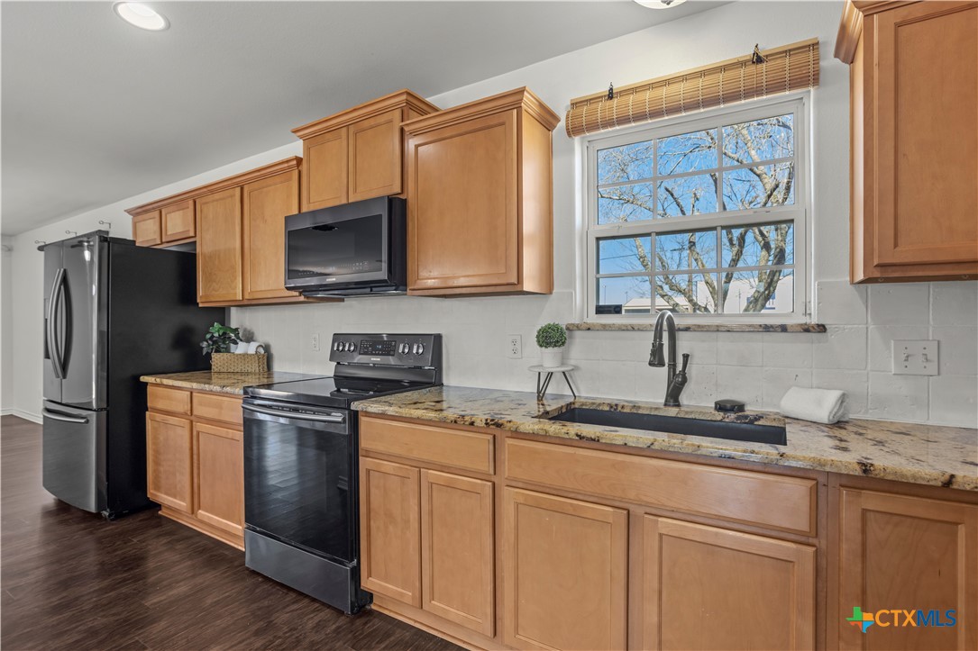 519 Pleasant View Road Troy, TX 76579 - Photo 7 of 33 a kitchen with stainless steel appliances granite countertop a refrigerator sink and microwave