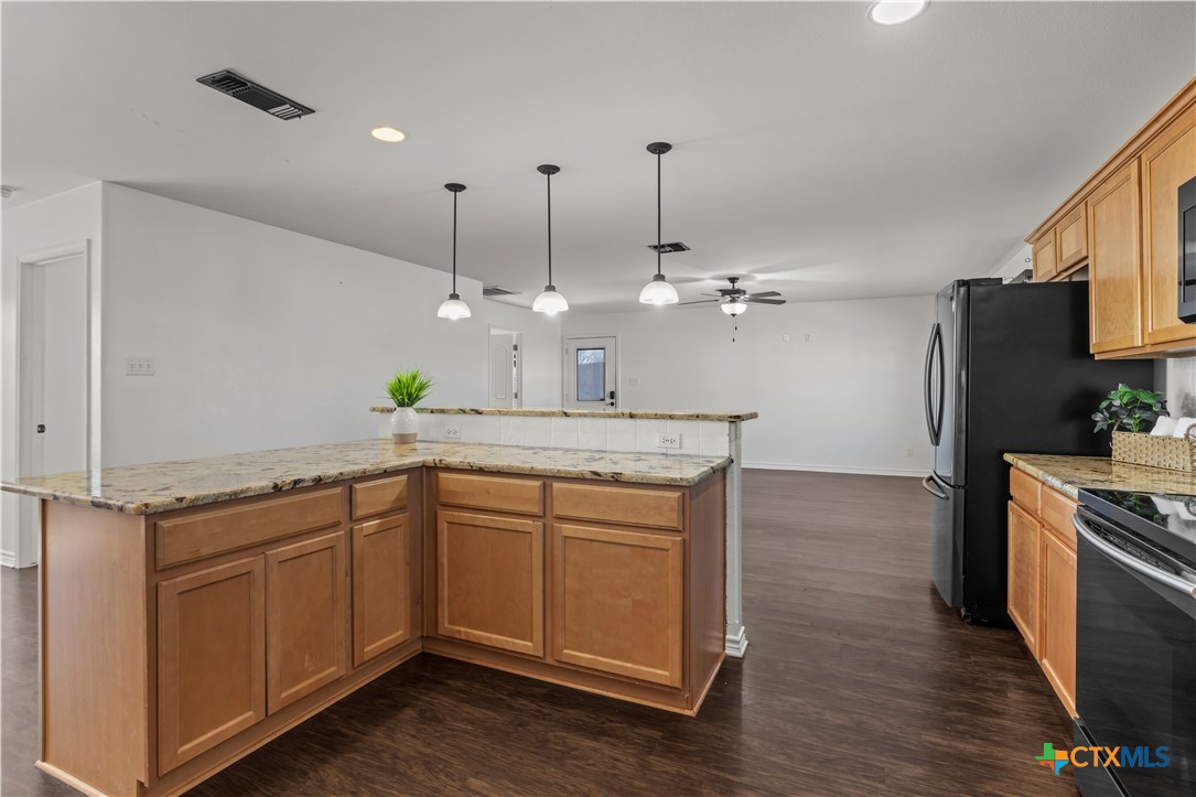 519 Pleasant View Road Troy, TX 76579 - Photo 9 of 33 a kitchen with kitchen island granite countertop a sink stainless steel appliances and cabinets