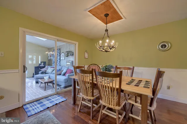 a view of a dining room with furniture and chandelier