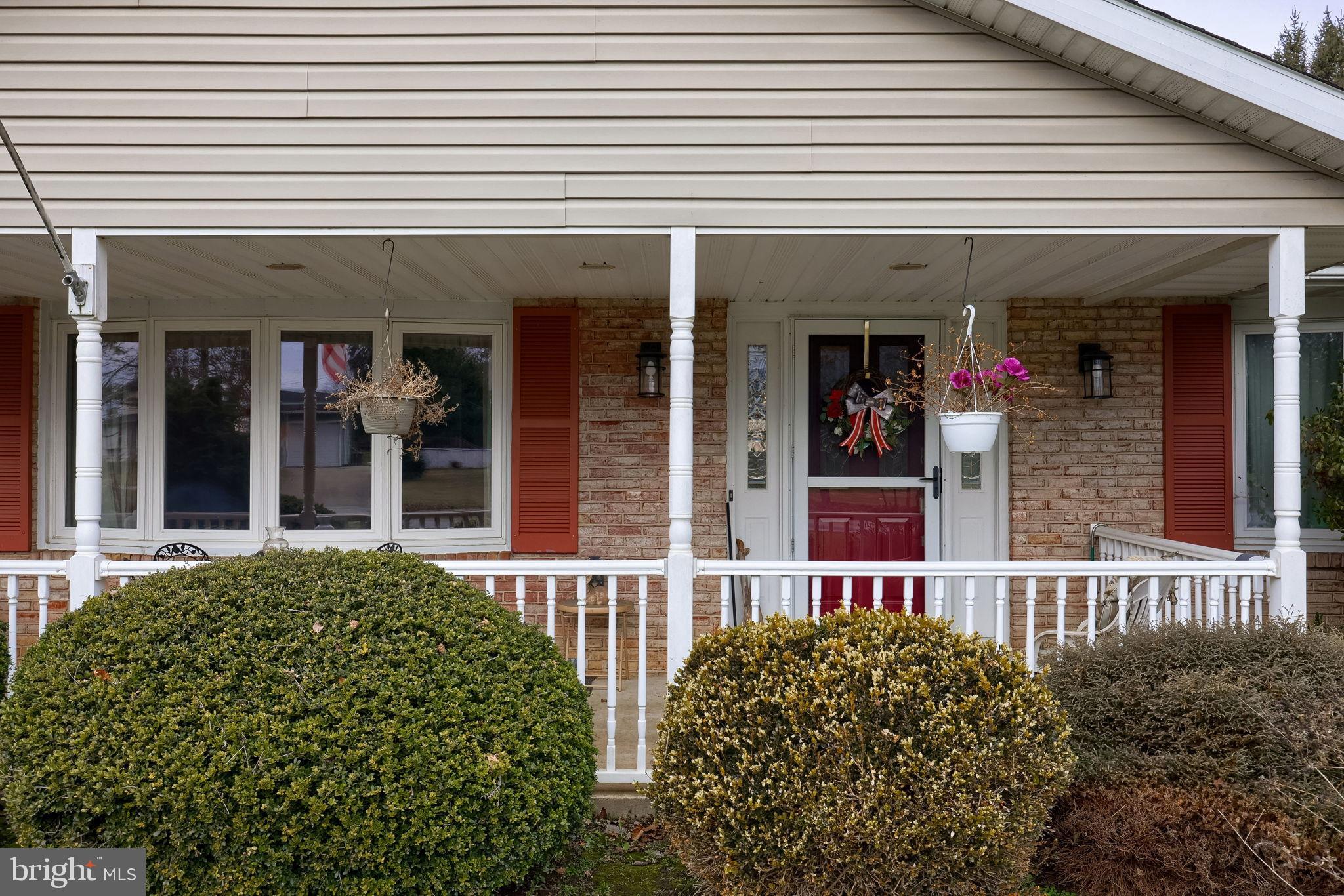 1019 Spring Valley Road Quarryville, PA 17566 - Photo 32 of 36 Charming porch with vibrant greenery.