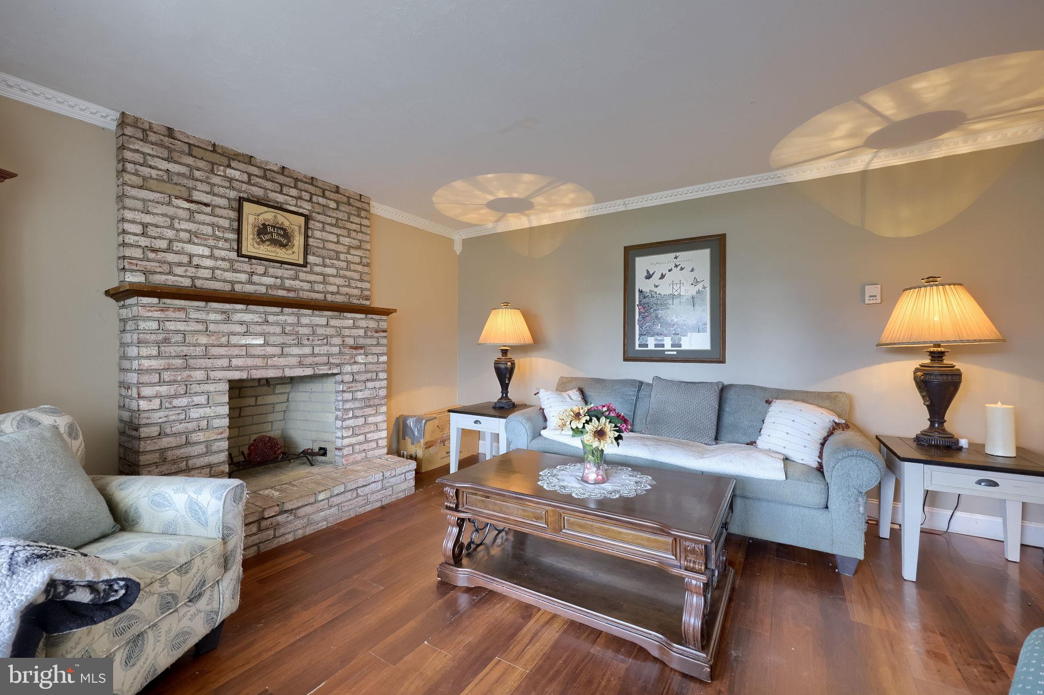 1019 Spring Valley Road Quarryville, PA 17566 - Photo 4 of 36 Cozy living space with charming brick fireplace.