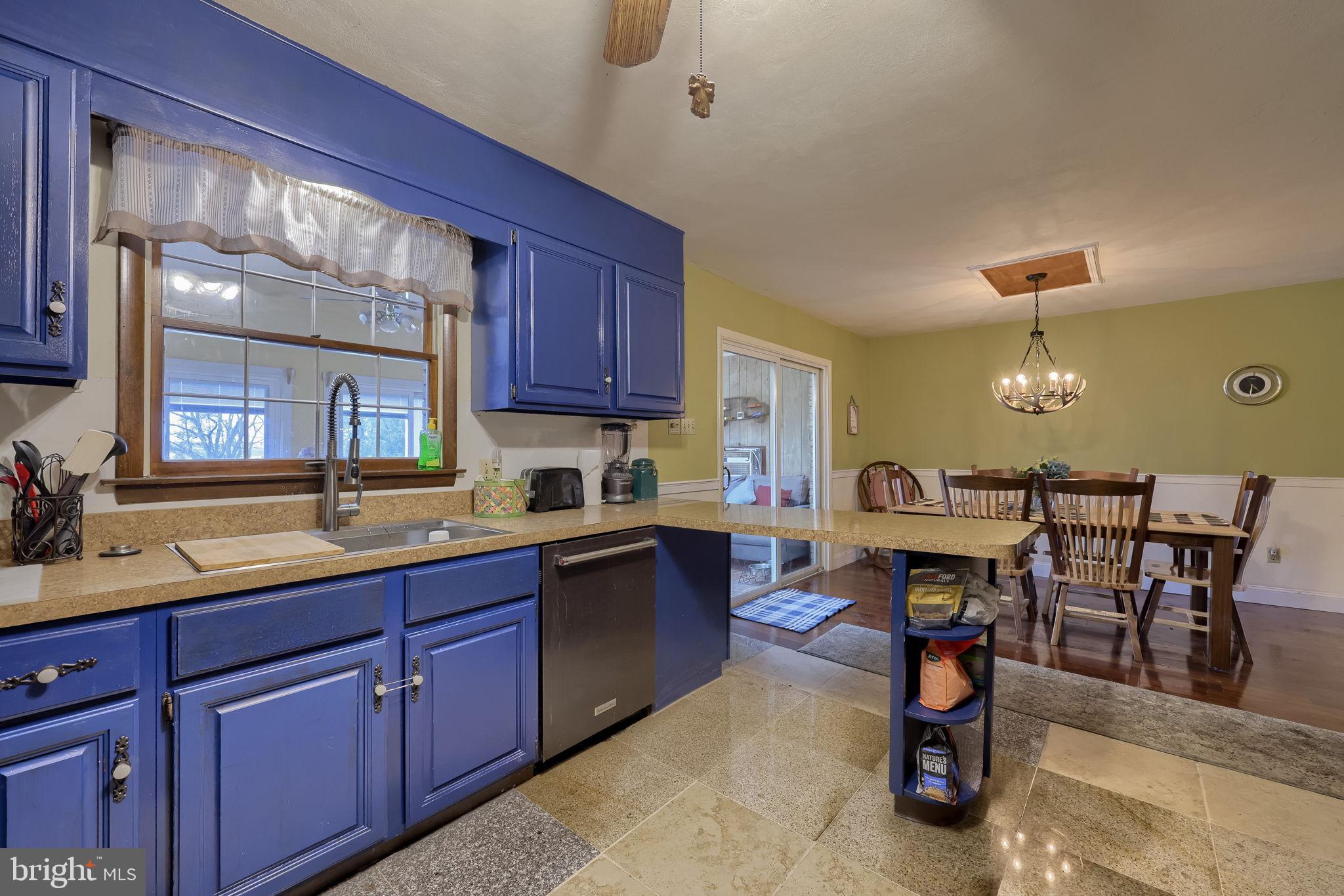1019 Spring Valley Road Quarryville, PA 17566 - Photo 10 of 36 Charming kitchen with vibrant blue cabinetry.