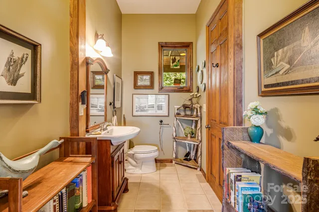 a bathroom with a sink mirror vanity and toilet