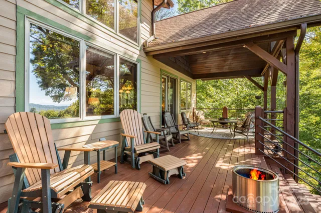 a view of balcony with chairs and wooden floor
