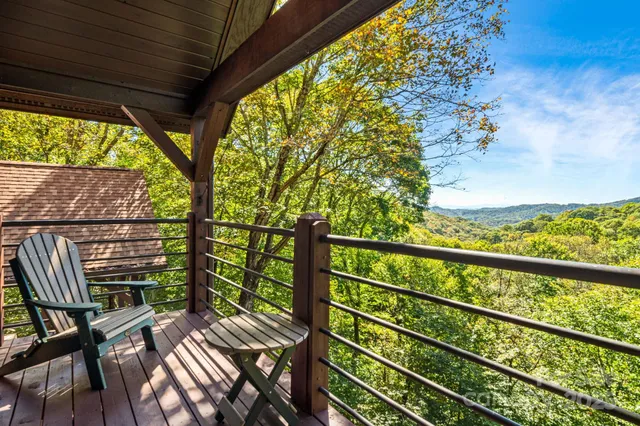 a view of balcony with wooden floor and outdoor seating
