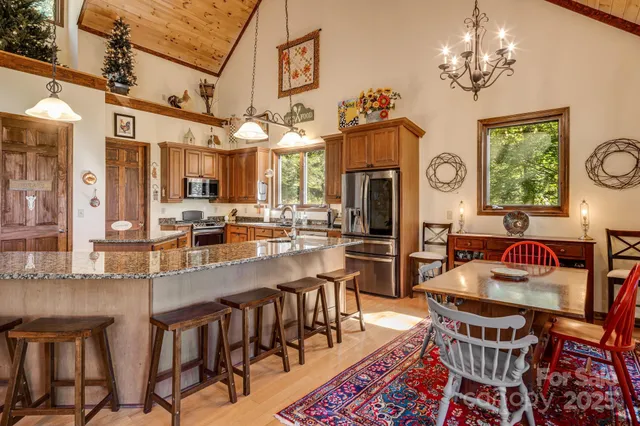 a view of a dining room with furniture a chandelier and wooden floor