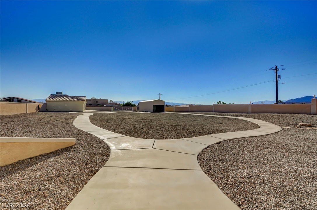 640 North Racetrack Road Henderson, NV 89015 - Photo 9 of 65 Pathways carve through a low-maintenance landscape, connecting various structures on this property.