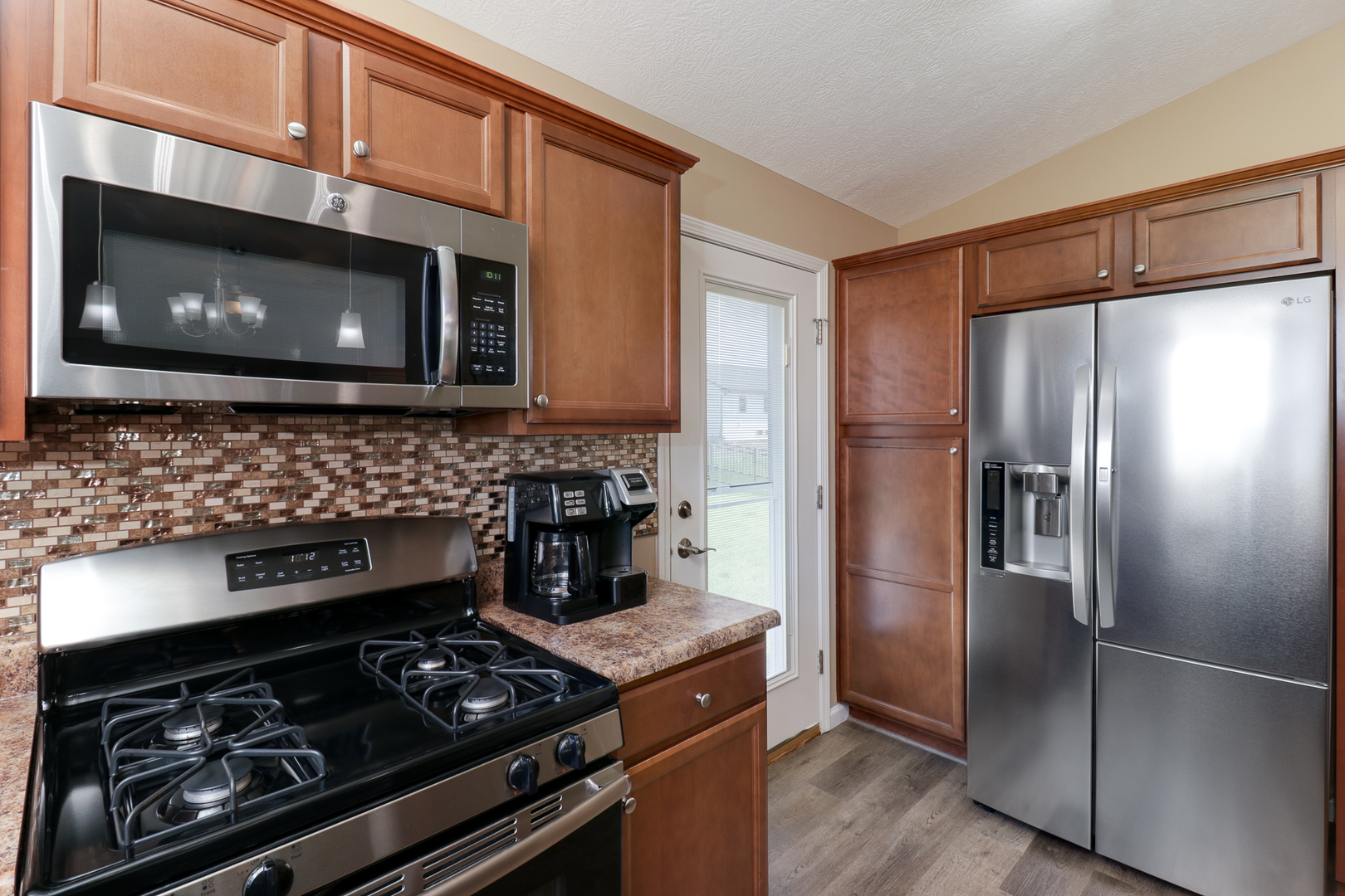 51 Winding Way Bloomington, IL 61705 - Photo 11 of 39 a kitchen with stainless steel appliances granite countertop a stove and a microwave