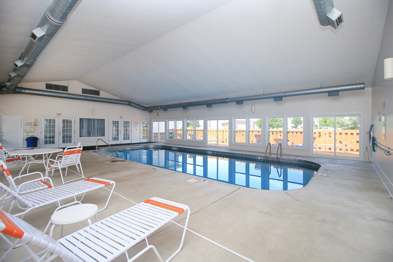 51 Winding Way Bloomington, IL 61705 - Photo 35 of 39 a view of a patio with couches table and chairs with wooden floor