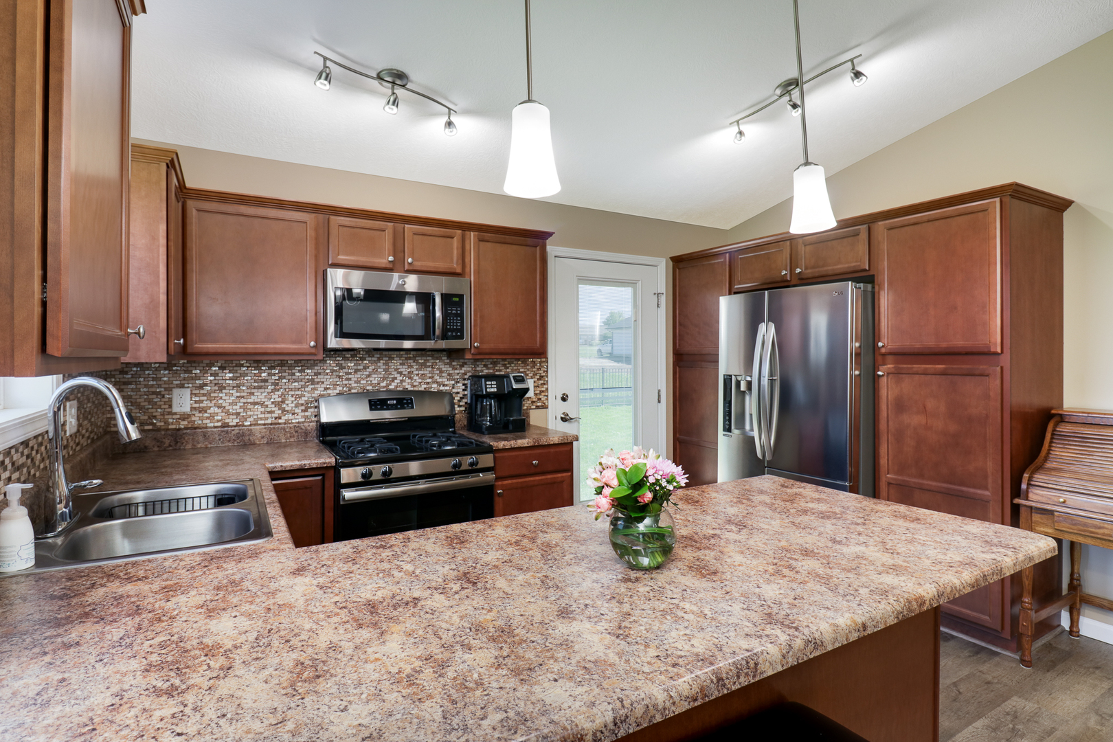 51 Winding Way Bloomington, IL 61705 - Photo 7 of 39 a kitchen with granite countertop a stove refrigerator and microwave with wooden floor