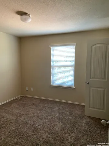 an empty room with a empty space and windows