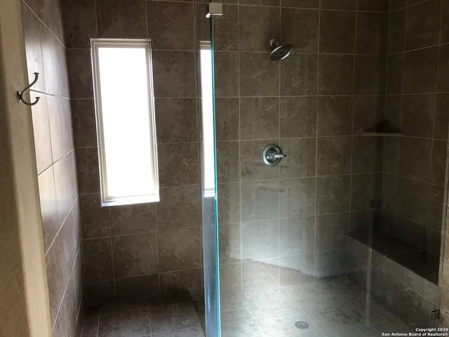 a bathroom with a glass shower door