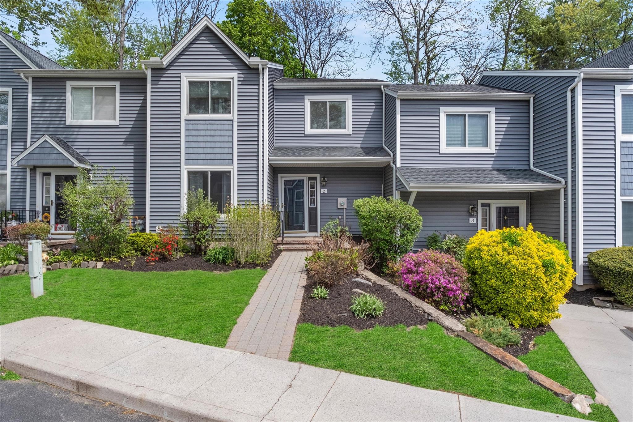 a front view of a house with garden