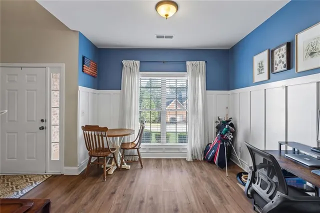 a view of a workspace with furniture and a window