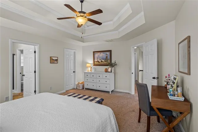 a bedroom with a bed chandelier and a window