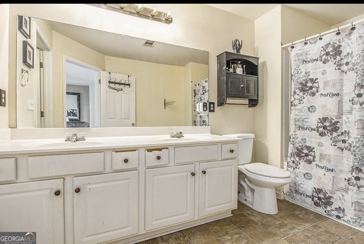 3669 Utoy Drive Southwest Atlanta, GA 30331 - Photo 13 of 22 a bathroom with a double vanity sink mirror and toilet