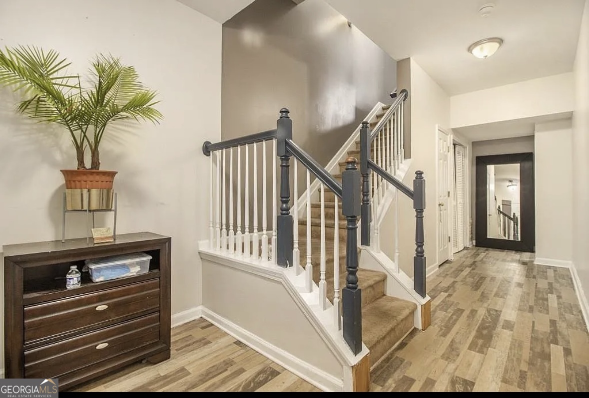 3669 Utoy Drive Southwest Atlanta, GA 30331 - Photo 6 of 22 a view of a hallway with wooden floor and staircase