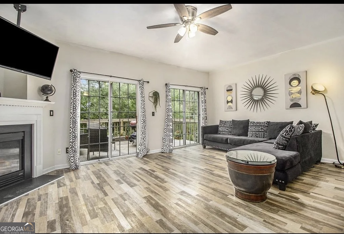 3669 Utoy Drive Southwest Atlanta, GA 30331 - Photo 7 of 22 a living room with furniture a flat screen tv and a fireplace