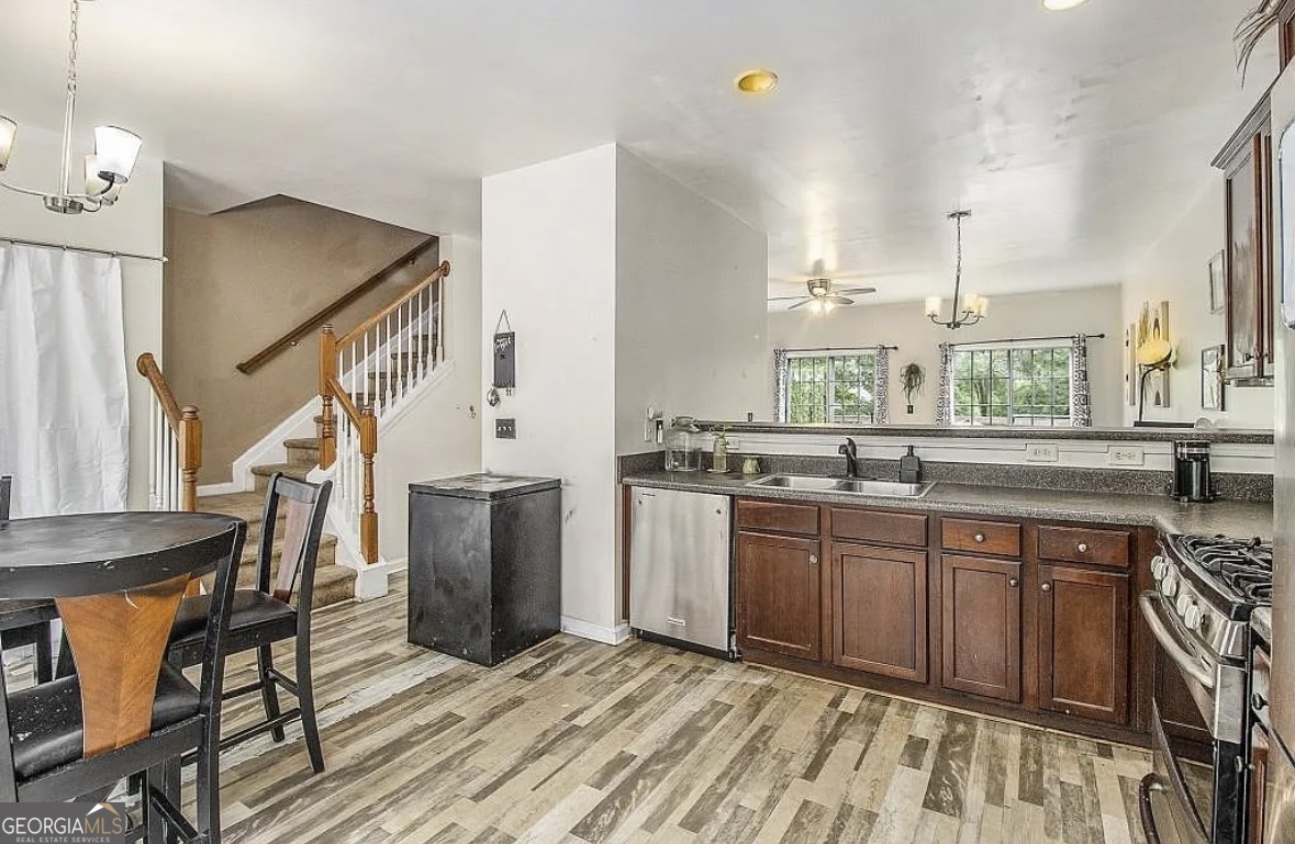 3669 Utoy Drive Southwest Atlanta, GA 30331 - Photo 9 of 22 a kitchen with stainless steel appliances granite countertop a sink and wooden floors