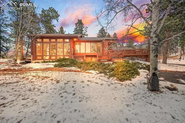 a view of a yard covered with snow in front of house