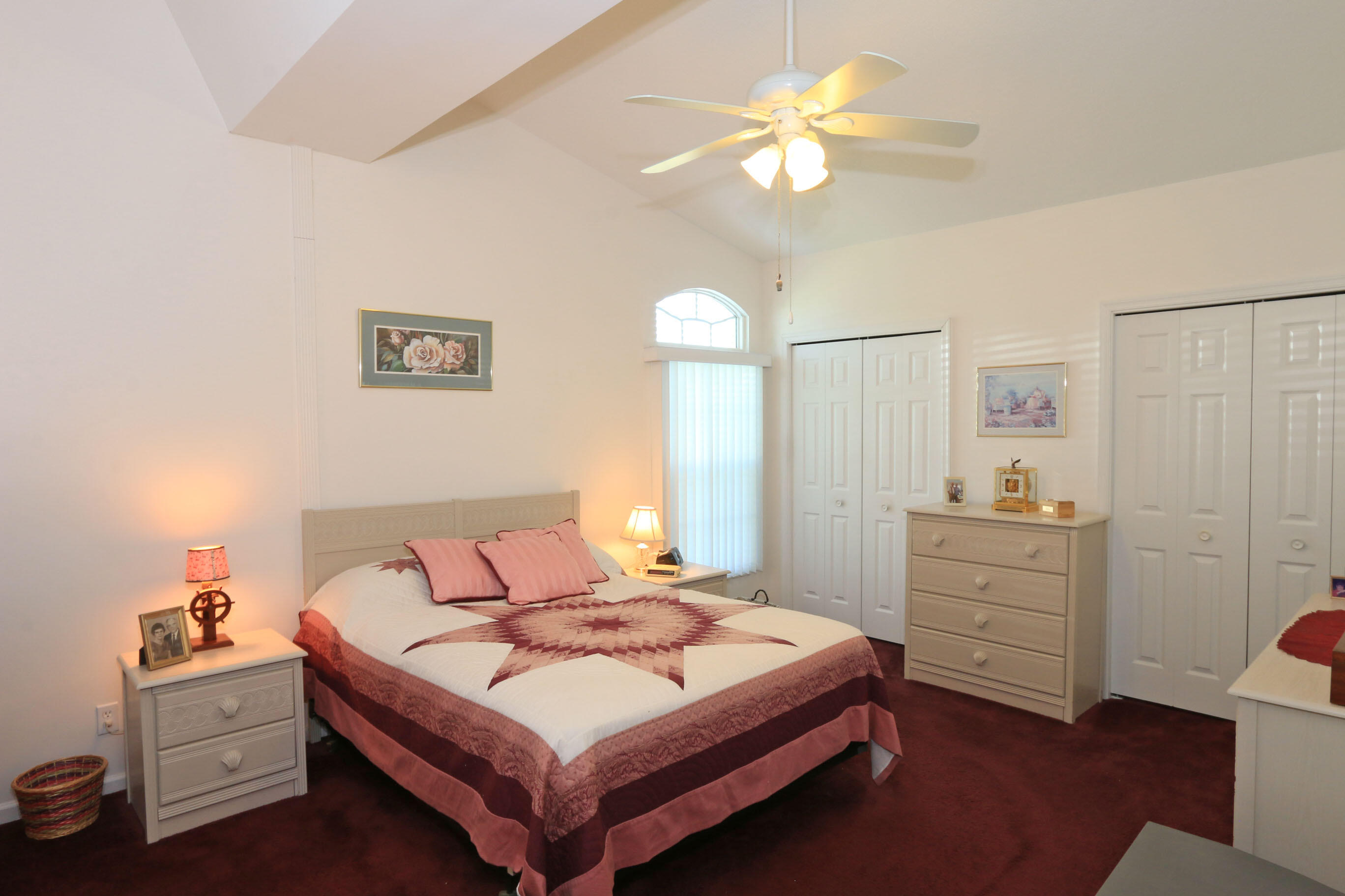 4350 Southwest 9th Way Okeechobee, FL 34974 - Photo 15 of 52 a bedroom with a bed and a chandelier