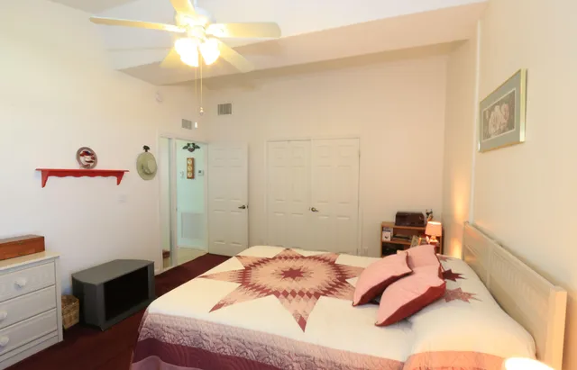 a bedroom with a bed and a chandelier