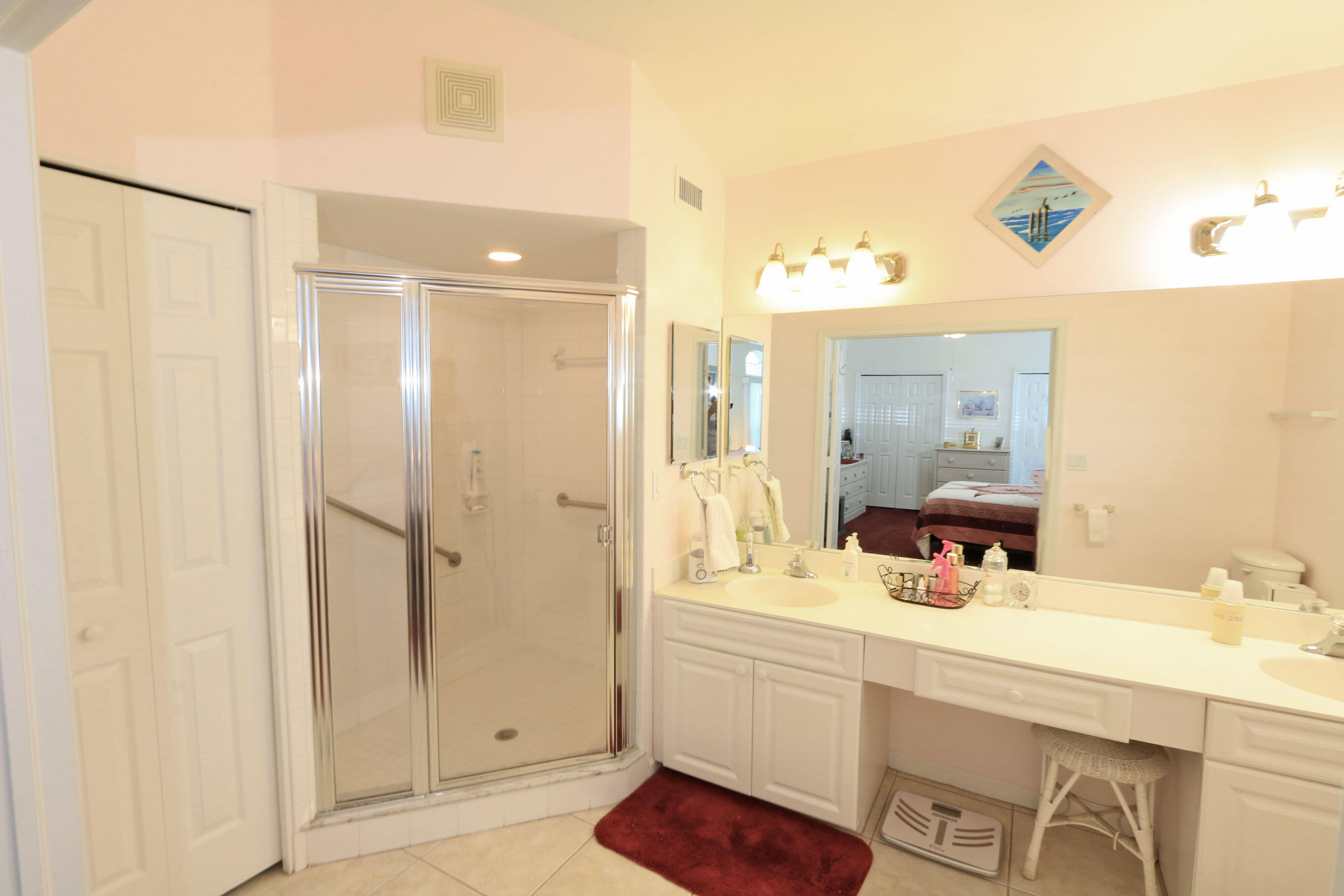 4350 Southwest 9th Way Okeechobee, FL 34974 - Photo 20 of 52 a bathroom with a double vanity sink a mirror and a shower