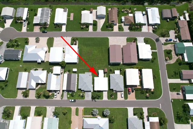 a view of house with a yard and potted plants