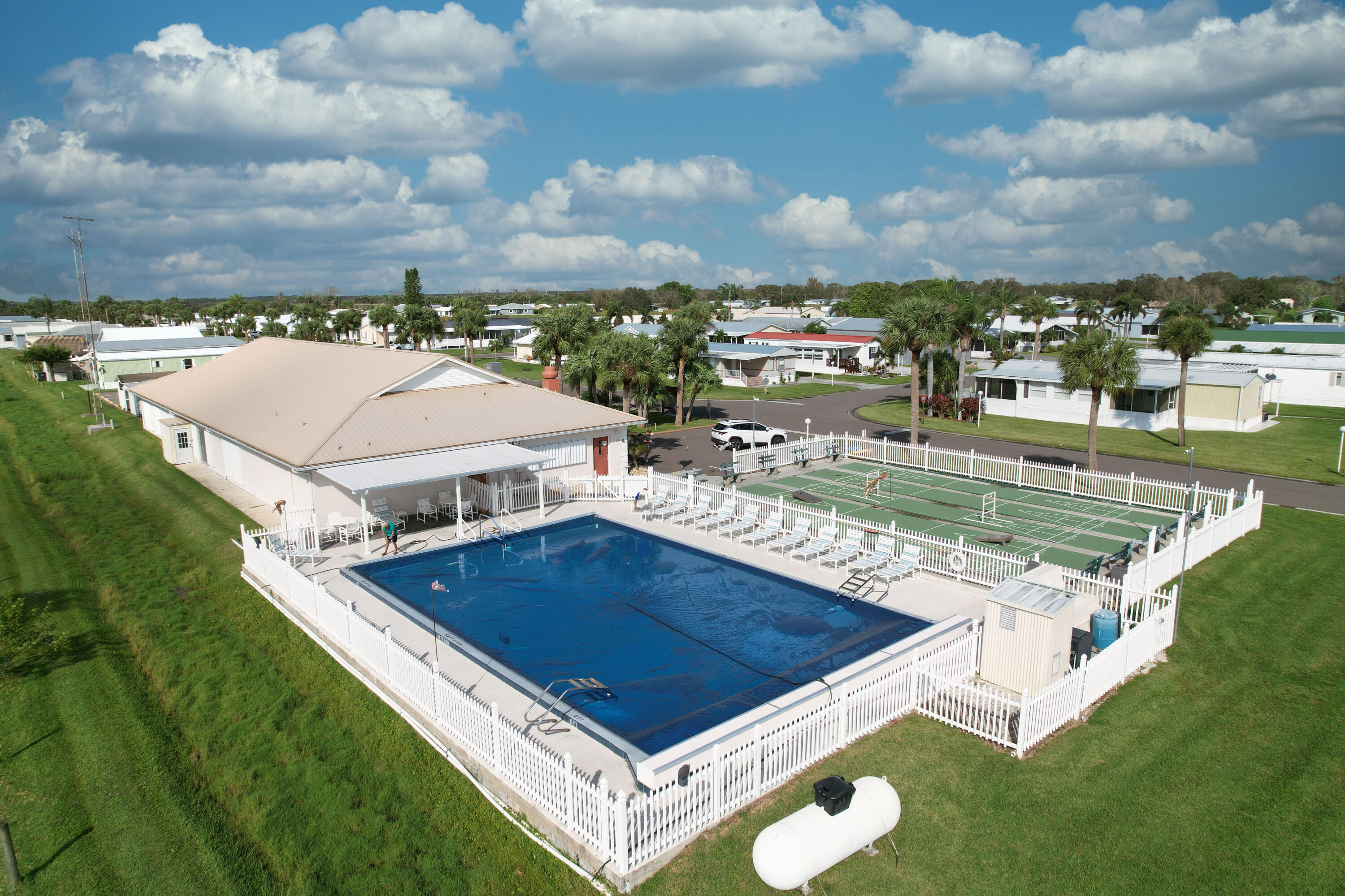 4350 Southwest 9th Way Okeechobee, FL 34974 - Photo 40 of 52 a view of a swimming pool with an outdoor seating and a lots of trees in the background