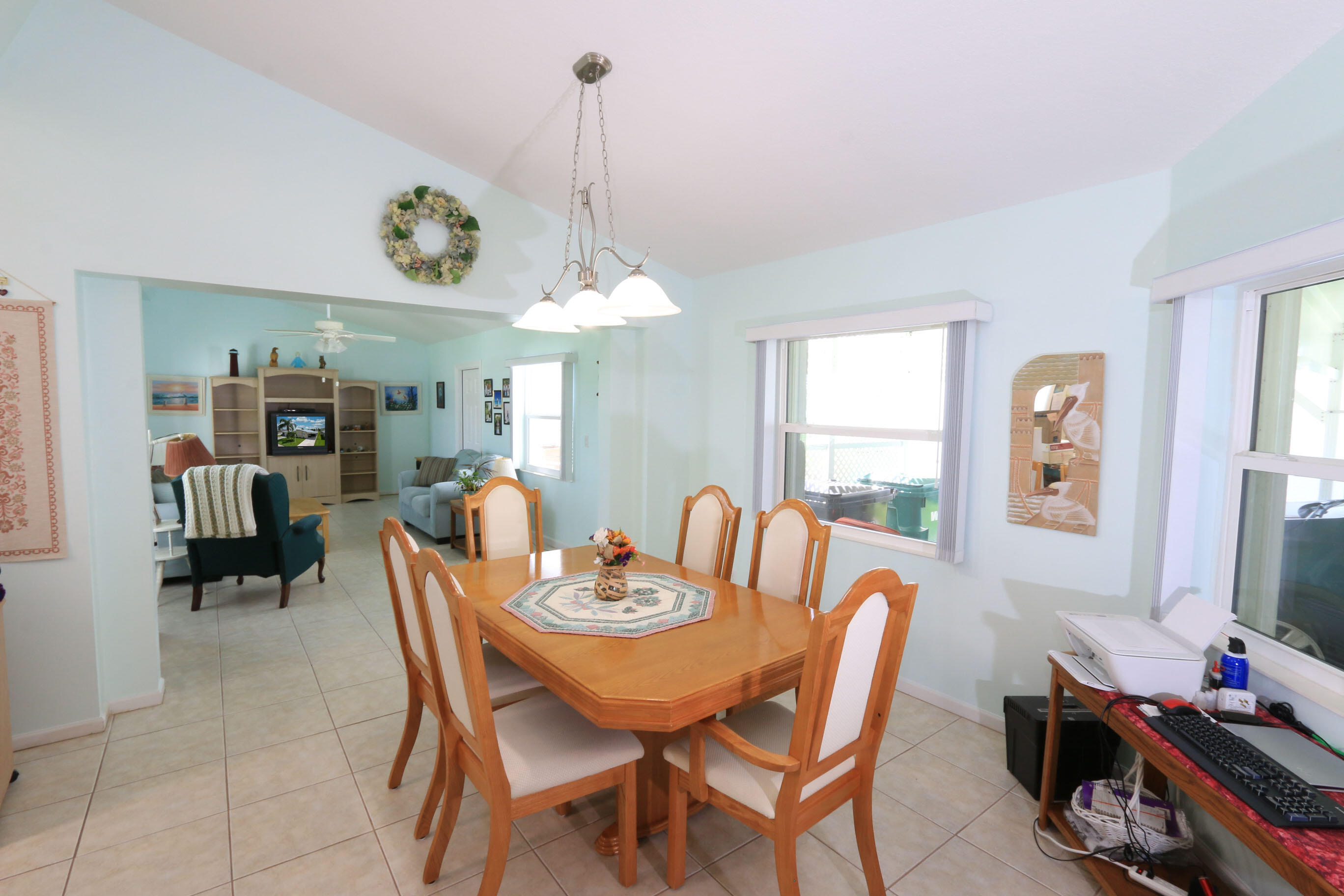 4350 Southwest 9th Way Okeechobee, FL 34974 - Photo 4 of 52 a view of a dining room and livingroom with furniture wooden floor a rug a painting and a chandelier